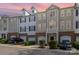 Exterior view of townhomes with attached garages, well-maintained landscaping, and colorful sky at 6912 Park Place Dr, Charlotte, NC 28262