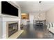 Open concept living room with fireplace, modern floors, and view of the kitchen at 6912 Park Place Dr, Charlotte, NC 28262