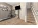 A spacious living room features a treadmill, a television, and access to the backyard at 6912 Park Place Dr, Charlotte, NC 28262