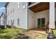 View of the ground level patio with sliding glass doors, white siding, and a grassy lawn at 6912 Park Place Dr, Charlotte, NC 28262