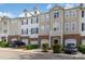 Exterior view of several multi-story townhomes with garages, siding, and brick at 6912 Park Place Dr, Charlotte, NC 28262