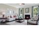 Inviting living room features a fireplace, plush white sofa, and neutral decor creating a cozy atmosphere at 7138 Butternut Oak Ter, Huntersville, NC 28078