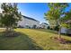 Spacious backyard with lush grass and mature trees with a view of neighboring homes at 7216 Old Valley Way, Harrisburg, NC 28075