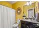 Bright bathroom with yellow walls, shower and tub combination at 7216 Old Valley Way, Harrisburg, NC 28075