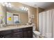 Bathroom with a double sink vanity, granite countertops, and neutral walls and floors at 7216 Old Valley Way, Harrisburg, NC 28075