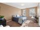 Bedroom with two windows allowing ample natural light, neutral walls and carpet at 7216 Old Valley Way, Harrisburg, NC 28075