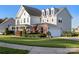 A two-story home with a white garage door and a lush green lawn at 7216 Old Valley Way, Harrisburg, NC 28075