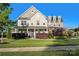 Charming two-story home with manicured lawn, blue door, and lush landscaping at 7216 Old Valley Way, Harrisburg, NC 28075