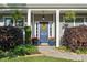Inviting entryway featuring a blue door, decorative wreath, and colorful potted plants at 7216 Old Valley Way, Harrisburg, NC 28075