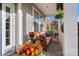 Charming front porch featuring a wicker couch and colorful plants at 7216 Old Valley Way, Harrisburg, NC 28075