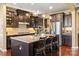 Spacious kitchen boasts a large granite island, stainless steel appliances, and pendant lighting at 7216 Old Valley Way, Harrisburg, NC 28075