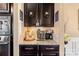 Coffee bar area features granite countertops, cabinetry, and stainless steel microwave oven at 7216 Old Valley Way, Harrisburg, NC 28075