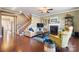 Cozy living room with a fireplace, hardwood floors, and comfortable seating at 7216 Old Valley Way, Harrisburg, NC 28075