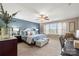 Bright main bedroom with a large window, decorative curtains, and neutral carpet at 7216 Old Valley Way, Harrisburg, NC 28075