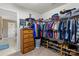 Walk-in closet with multiple shelves and hanging clothes with a dresser at 7216 Old Valley Way, Harrisburg, NC 28075