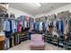 Well-organized walk-in closet with plush seating and tiered shoe racks at 7216 Old Valley Way, Harrisburg, NC 28075