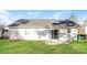 Spacious backyard with lush green grass and a home's back exterior at 7830 Lobilia Ln, Charlotte, NC 28214