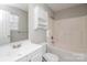 Clean bathroom featuring a white vanity, toilet, shower, and bathtub, enhanced with a wall cabinet for storage at 7830 Lobilia Ln, Charlotte, NC 28214