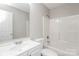 A bright bathroom featuring a vanity, toilet, and shower over tub at 7830 Lobilia Ln, Charlotte, NC 28214
