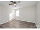 Bright bedroom featuring a ceiling fan, neutral walls, modern floors, and ample natural light through the window at 7830 Lobilia Ln, Charlotte, NC 28214