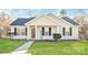 Charming home featuring well-maintained lawn, sidewalk, and classic architectural details under a bright, partly cloudy sky at 7830 Lobilia Ln, Charlotte, NC 28214