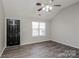 Bright living room featuring high ceilings, a ceiling fan, attractive gray floors, and a black front door at 7830 Lobilia Ln, Charlotte, NC 28214