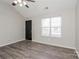 Bright living room featuring high ceilings, a ceiling fan, attractive gray floors, and a black front door at 7830 Lobilia Ln, Charlotte, NC 28214