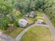 Aerial shot of a quaint property with a fenced backyard, detached garage, and a gravel driveway at 804 Allen Dr, Marshville, NC 28103