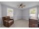 Comfortable bedroom with plush chair, neutral carpet, and bright natural light from windows at 804 Allen Dr, Marshville, NC 28103
