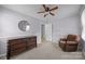 Cozy bedroom with round mirror, plush chair, carpet, and ample natural light at 804 Allen Dr, Marshville, NC 28103