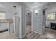 Hallway with wood floors offers access to the kitchen, bedroom, and bathroom at 804 Allen Dr, Marshville, NC 28103