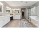 Bright bathroom featuring double vanities, a glass-enclosed shower, and a separate bathtub at 8709 Barrelli Ct, Charlotte, NC 28277