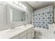 Bright bathroom with double sinks, a decorative mirror, and a patterned shower curtain at 8709 Barrelli Ct, Charlotte, NC 28277