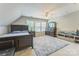 Comfortable bedroom with neutral tones, ceiling fan, and ample natural light from the large window at 8709 Barrelli Ct, Charlotte, NC 28277