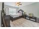 Elegant bedroom with a decorative bed frame, stylish furnishings, and a ceiling fan at 8709 Barrelli Ct, Charlotte, NC 28277