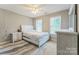 Well-lit bedroom with a queen-sized bed, ceiling fan, and soft neutral color palette at 8709 Barrelli Ct, Charlotte, NC 28277
