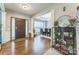 Inviting foyer with hardwood floors, elegant pillars, and a view into the adjacent dining area at 8709 Barrelli Ct, Charlotte, NC 28277
