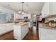 Modern kitchen with white cabinets, granite countertops, stainless steel appliances, and hardwood floors at 8709 Barrelli Ct, Charlotte, NC 28277
