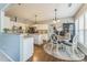 Open-concept kitchen featuring white cabinetry, granite countertops, stainless steel appliances, and a breakfast nook at 8709 Barrelli Ct, Charlotte, NC 28277