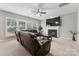 Comfortable living room with plush leather sofas, a fireplace, and a large screen television at 8709 Barrelli Ct, Charlotte, NC 28277