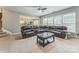 Spacious living room showcasing a large sectional sofa and a view into the adjacent kitchen at 8709 Barrelli Ct, Charlotte, NC 28277