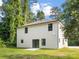 Backyard featuring a lush lawn and sliding door access to a patio at 8717 Lawyers Rd, Charlotte, NC 28227