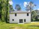 Backyard featuring a lush lawn and sliding door access to a patio at 8717 Lawyers Rd, Charlotte, NC 28227