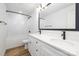 Modern bathroom featuring double sinks, wood-look flooring and bathtub shower combo at 8717 Lawyers Rd, Charlotte, NC 28227