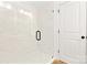 Modern bathroom features a glass shower with marble-style tiling and black hardware at 8717 Lawyers Rd, Charlotte, NC 28227