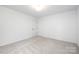 Bright bedroom featuring plush carpet and neutral walls, and a single door closet at 8717 Lawyers Rd, Charlotte, NC 28227