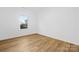 Empty bedroom features a window and hardwood floors at 8717 Lawyers Rd, Charlotte, NC 28227