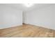 Spacious bedroom featuring neutral walls and durable wood-look flooring at 8717 Lawyers Rd, Charlotte, NC 28227