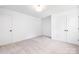 Bright bedroom featuring plush carpet and neutral walls, and a double and single door closet at 8717 Lawyers Rd, Charlotte, NC 28227