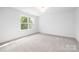 Bright bedroom featuring plush carpet and natural light from a window at 8717 Lawyers Rd, Charlotte, NC 28227